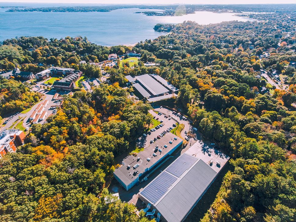 Aerial view of the solar canopy parking lot and the panels on top of the Raymond J. Bourque Arena