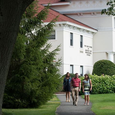 side shot of van loan school with students walking on path nearby