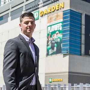 student outside athletic stadium at internship site