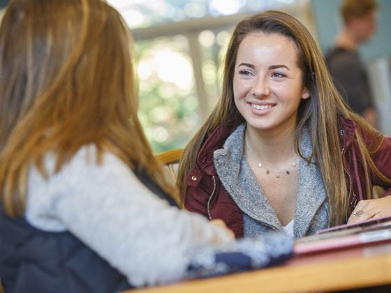 two students socializing in lounge area