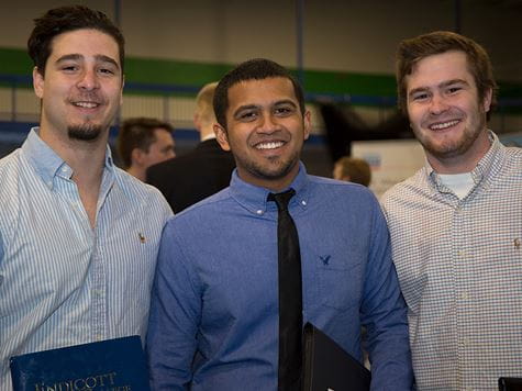 three students dressed up at job/career fair