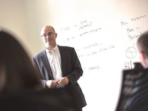 professor using white board to teach class