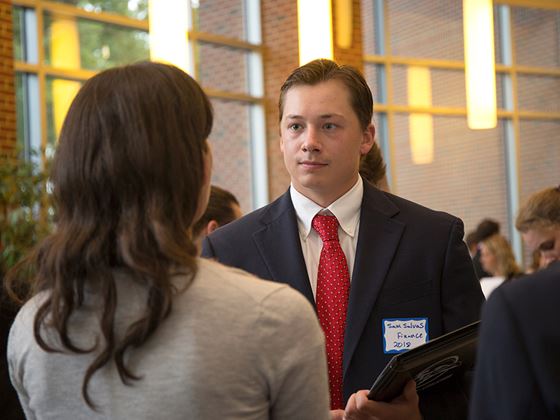 a financial student in a business suit meeting with a woman