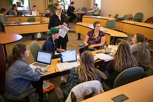 Students with laptops working around a table