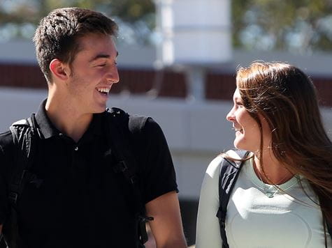 two students socializing as they walk to class