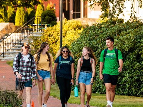 four students walk to class together