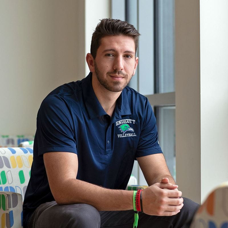 Seth Braquet seated in the Ginger Judge Science Center