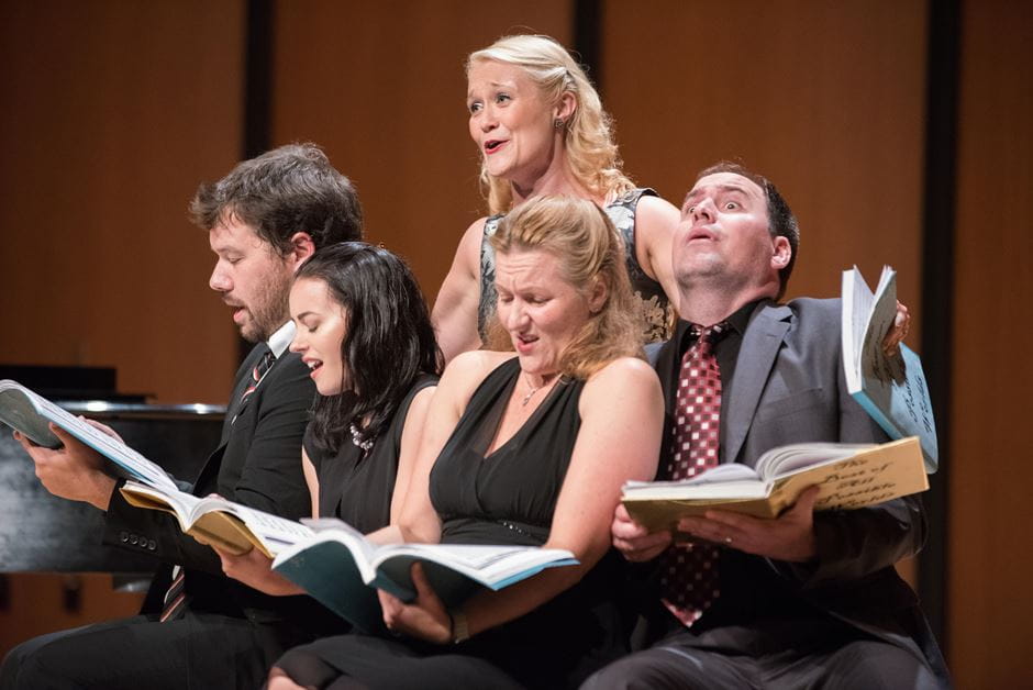 Faculty and students sing a choral performance 