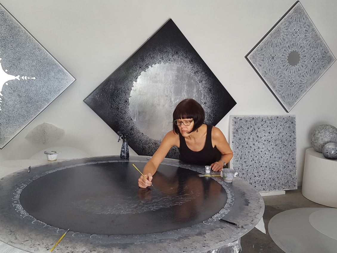 Artist Carol Pusa works in her studio