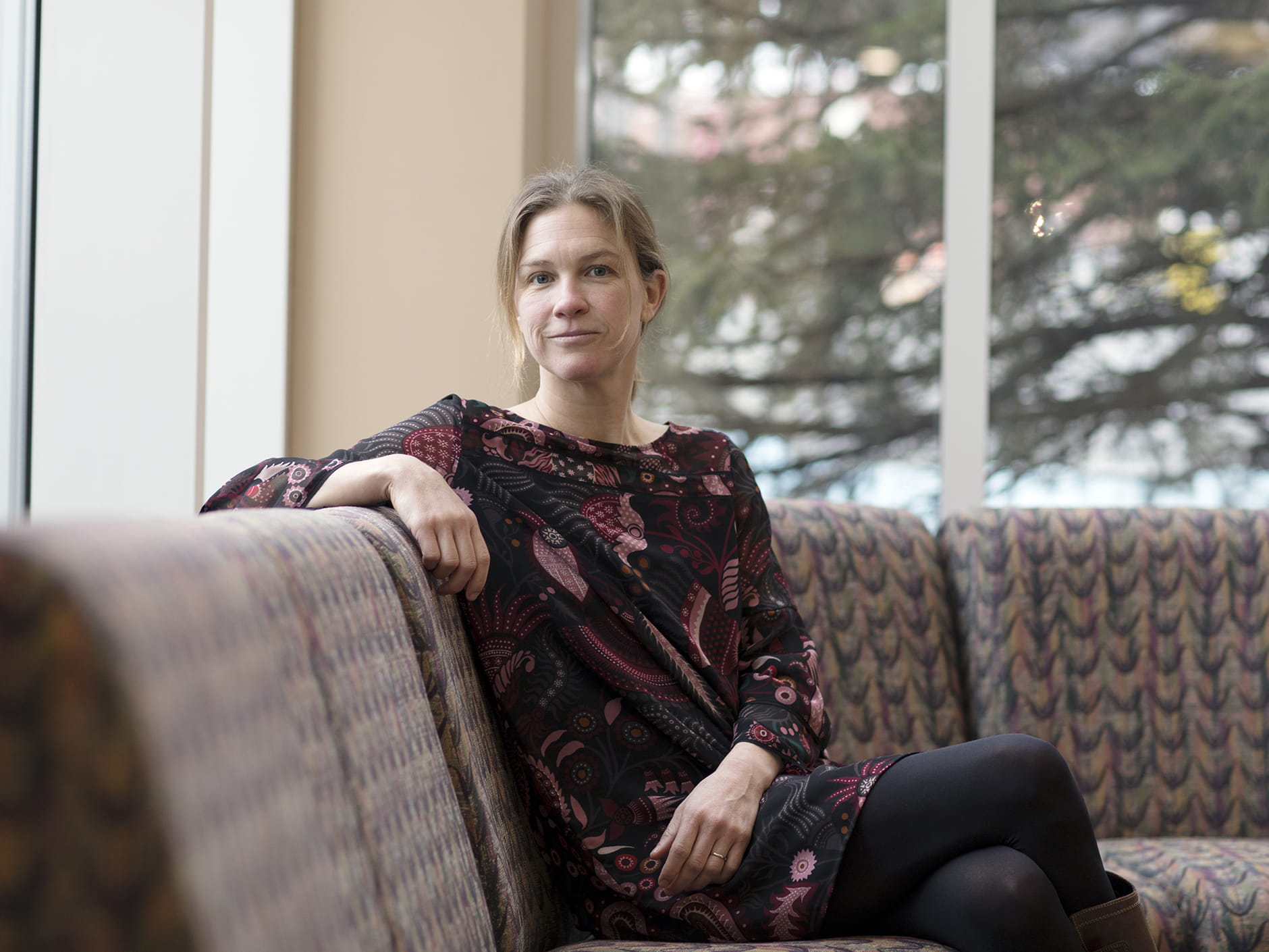 Elizabeth Winthrop sitting on a chair in the Halle Library. 
