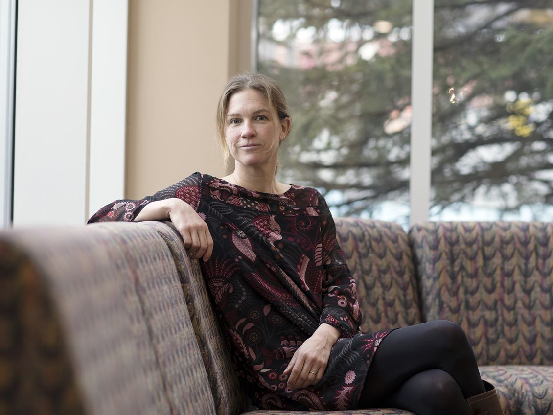 Elizabeth Winthrop sitting on a chair in the Halle Library. 