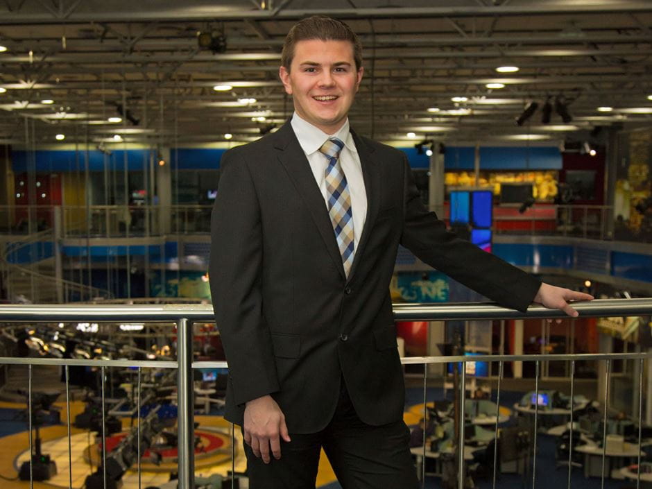 Matt Leighton posing in a newsroom