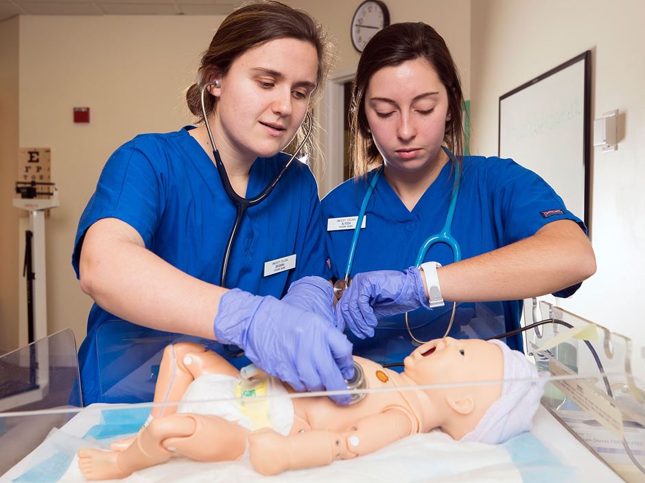 Faith Barbin '18 and a classmate working on a simulator baby