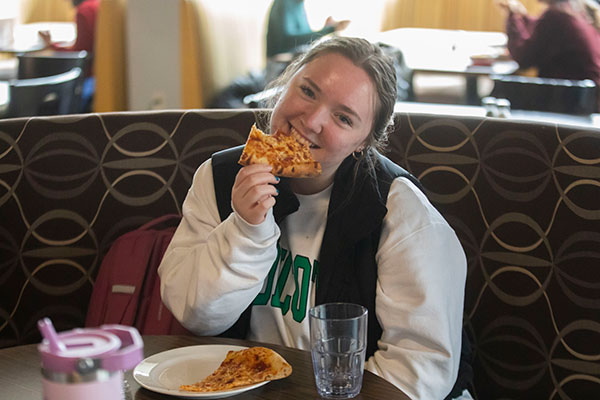Student eating pizza