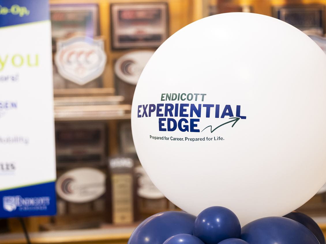 A white balloon with the Endicott Experiential Edge logo