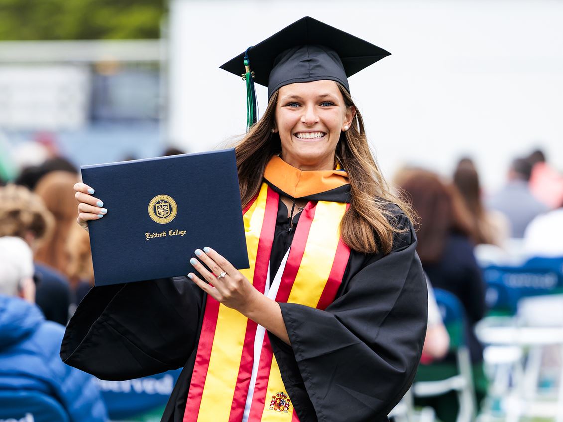 Student holding diploma at commencement