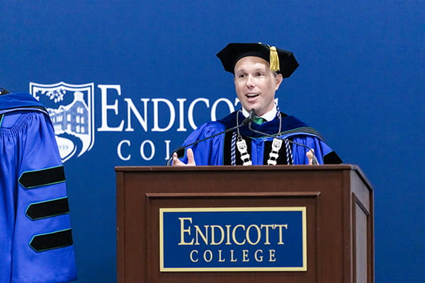 President Bryan Cain, Ph.D., at a podium during Inauguration & Convocation at Endicott College
