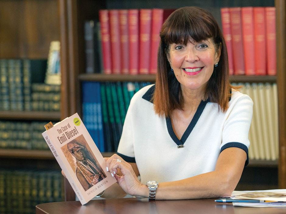 Endicott alumna Patricia Scangas holds her book