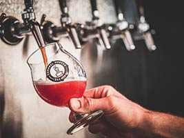 glass filling with beverage at tap