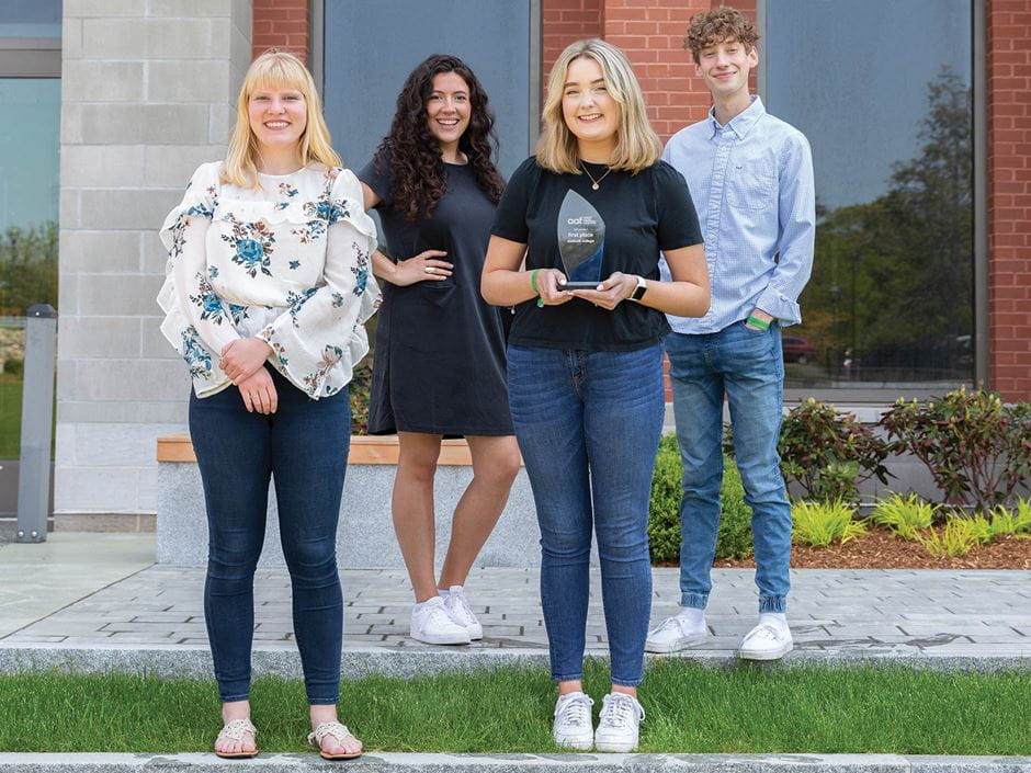 group picture outside of a buildings first floor window