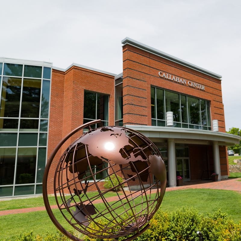 angled shot of callahan center and globe sculpture in front of building