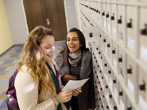 two students checking for mail in mail center