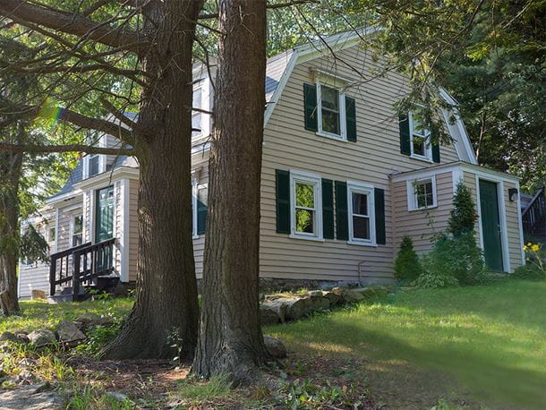 a view of a tan colored farm house