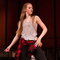 a woman posing in a student faculty recital