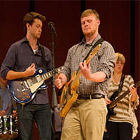 two band members playing their guitar