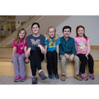 five kids sitting together for a group shot