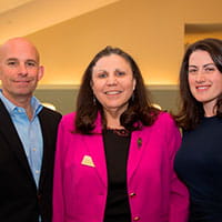 three people standing together for a photo