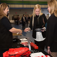 3 women at table at internship fair