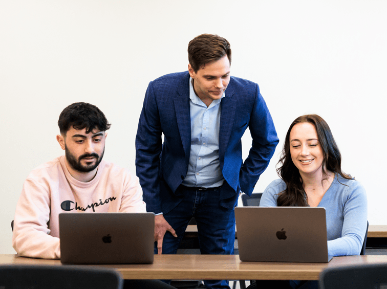 Professor in class with two students