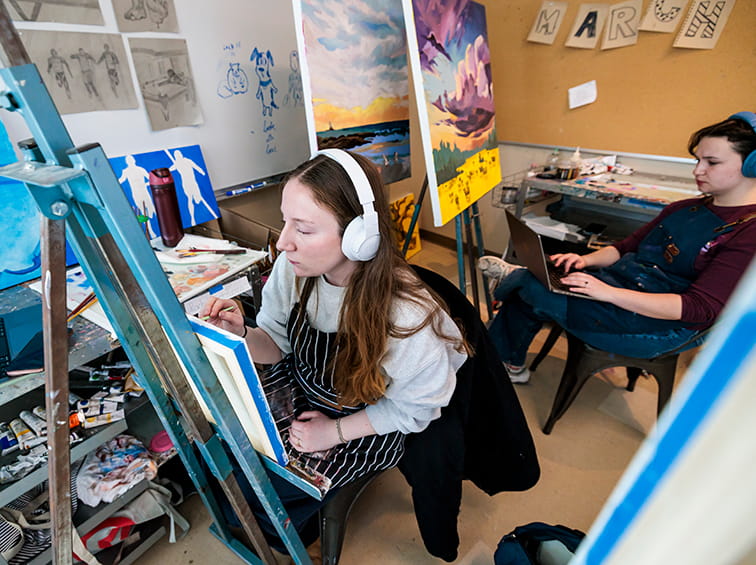 Students painting in a class
