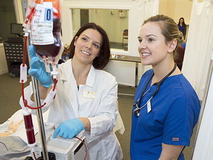 a nurse instructing one of her tests with the use of a patient dummy