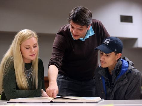 a student success faculty member helping two students