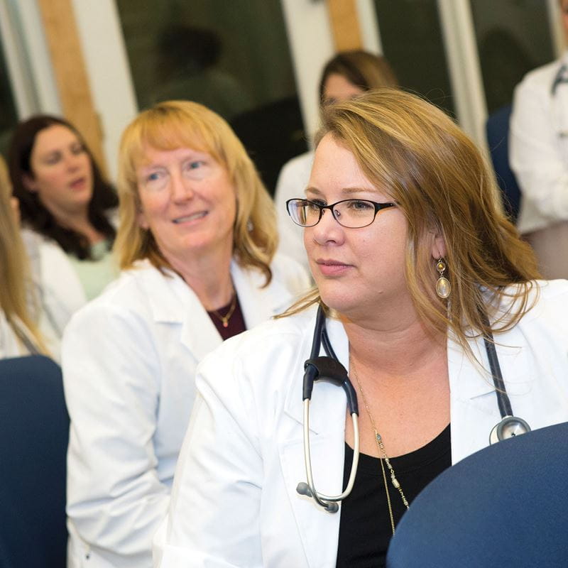 Nurses in white lab coats