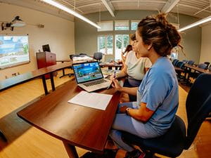 Nurse working with a faculty member in a classroom